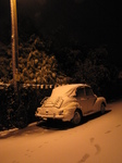 SX25879 Old car covered in snow parked under street light Llantwit Major.jpg